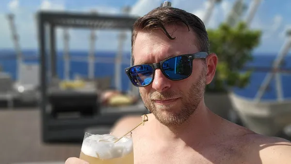 Enjoying a Honeycomb Goldrush Cocktail At the Retreat Sundeck on Celebrity Edge